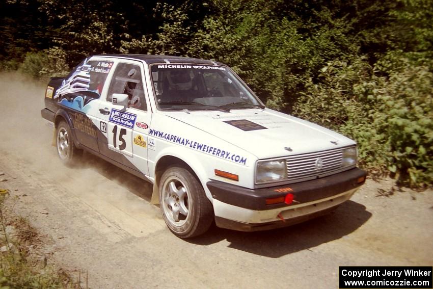 Brad Hawkins / Adrian Wintle VW Jetta at speed over a bridge on SS5, Magalloway North.