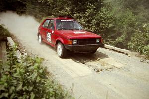 Jon Butts / Gary Butts Dodge Omni at speed over a bridge on SS5, Magalloway North.