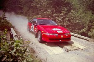 Brendan Cunningham / Paul McClean Eagle Talon at speed over a bridge on SS5, Magalloway North.