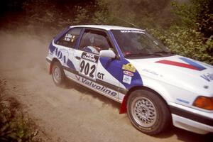 Marty Allen / Stewart Allen Mazda 323GTX at speed over a bridge on SS5, Magalloway North.