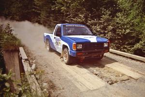 Anders Green / Jeff Denton Dodge Ram 50 at speed over a bridge on SS5, Magalloway North.