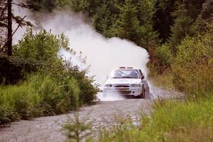 Stig Blomqvist / Lance Smith Ford Escort Cosworth RS splashes through a puddle on SS8, Parmachenee Long.