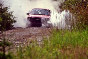 Jon Kemp / Rod Hendricksen Audi 4000 Quattro splashes through a puddle on SS8, Parmachenee Long.