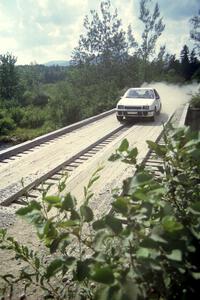 Henry Krolikowski / Cindy Krolikowski Dodge Shadow at speed over a bridge on SS8, Parmachenee Long.