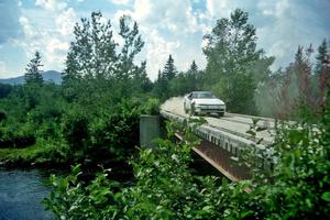 Chris Czyzio / Eric Carlson Mitsubishi Eclipse GSX at speed over a bridge on SS8, Parmachenee Long.