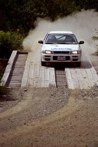Greg Healey / John MacLeod Subaru Impreza at speed over a bridge on SS8, Parmachenee Long.