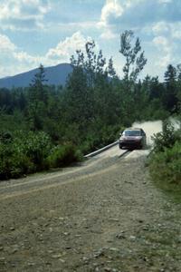 Evan Moen / Tom Young  Plymouth Neon ACR at speed over a bridge on SS8, Parmachenee Long.