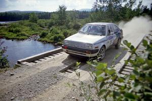 Brad Hawkins / Adrian Wintle VW Jetta at speed over a bridge on SS8, Parmachenee Long.