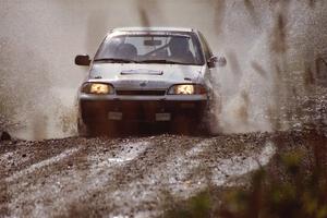 Ilana Rosenshein / Jennifer Cote Suzuki Swift GTi splashes through a puddle on SS8, Parmachenee Long.