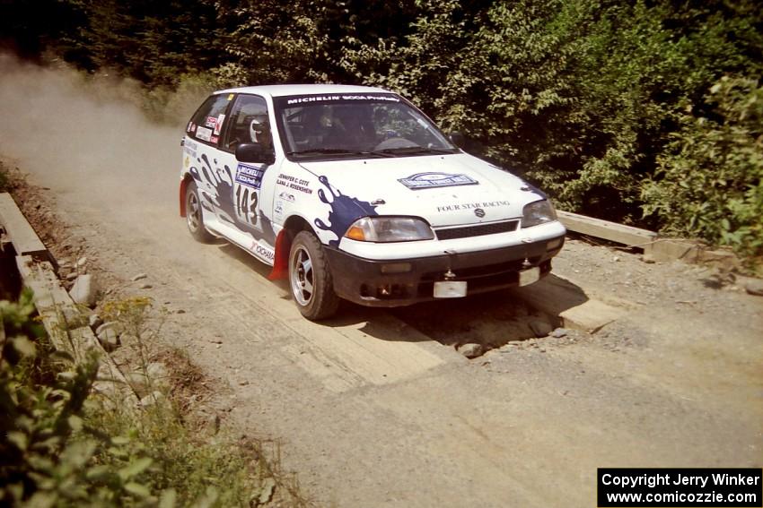 Ilana Rosenshein / Jennifer Cote Suzuki Swift GTi at speed over a bridge on SS5, Magalloway North.