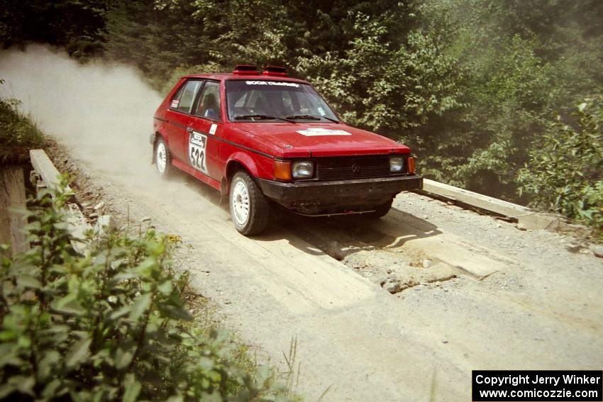 Jon Butts / Gary Butts Dodge Omni at speed over a bridge on SS5, Magalloway North.