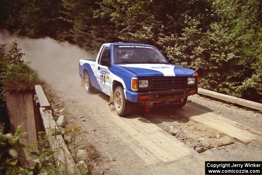 Anders Green / Jeff Denton Dodge Ram 50 at speed over a bridge on SS5, Magalloway North.