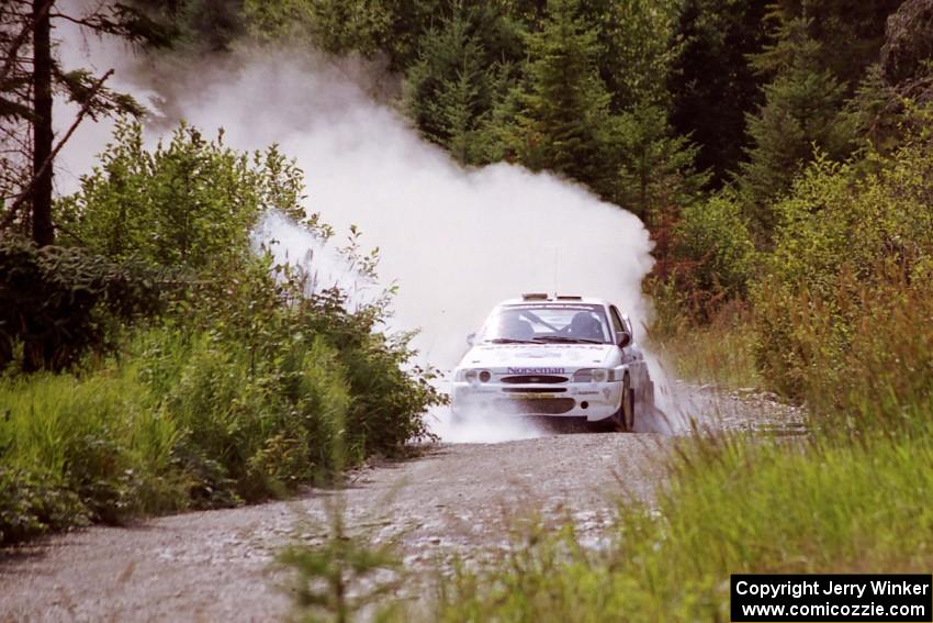 Stig Blomqvist / Lance Smith Ford Escort Cosworth RS splashes through a puddle on SS8, Parmachenee Long.
