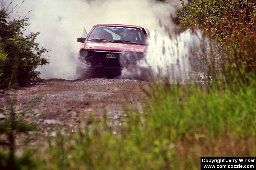Jon Kemp / Rod Hendricksen Audi 4000 Quattro splashes through a puddle on SS8, Parmachenee Long.