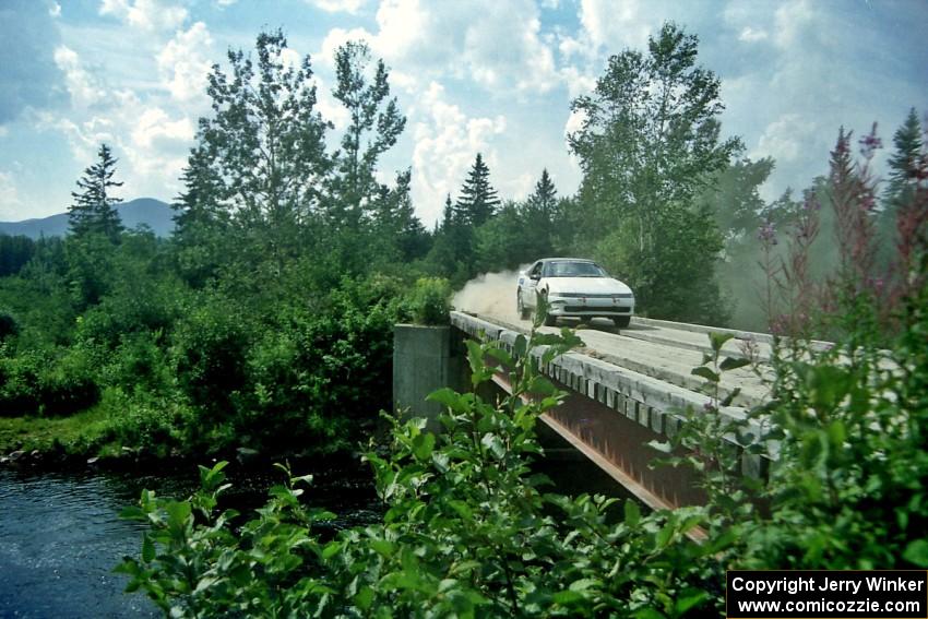 Chris Czyzio / Eric Carlson Mitsubishi Eclipse GSX at speed over a bridge on SS8, Parmachenee Long.