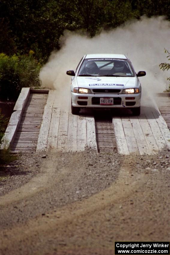 Greg Healey / John MacLeod Subaru Impreza at speed over a bridge on SS8, Parmachenee Long.