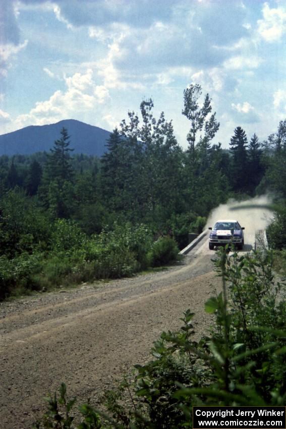 Alex Erisoty / Ben Greisler Audi 90 Quattro at speed over a bridge on SS8, Parmachenee Long.