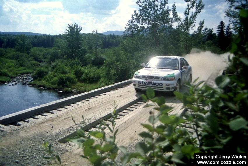 Peter Malaszuk / Darek Szerejko Daewoo Nubira at speed over a bridge on SS8, Parmachenee Long.