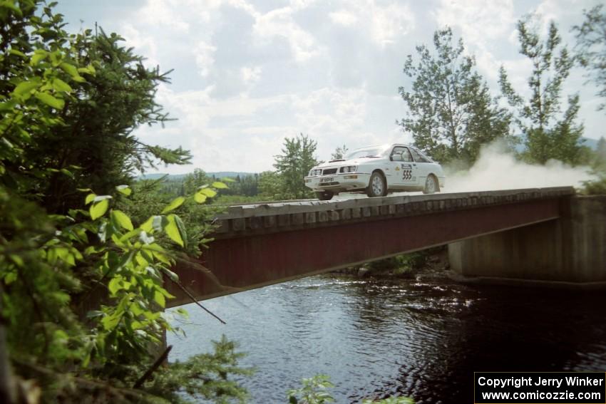 Colin McCleery / Jeff Secor Merkur XR4Ti at speed over a bridge on SS8, Parmachenee Long.
