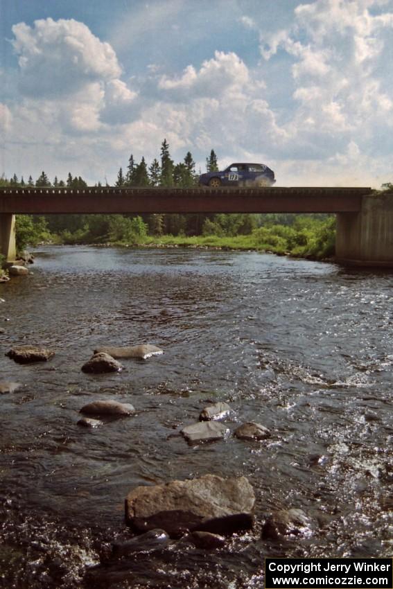 Patrick Lilly / Mark McAllister VW GTI at speed over a bridge on SS8, Parmachenee Long.