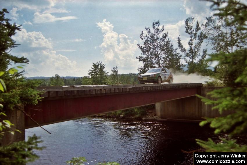 Donal Mulleady / John Reilly Mazda 323GTX at speed over a bridge on SS8, Parmachenee Long.