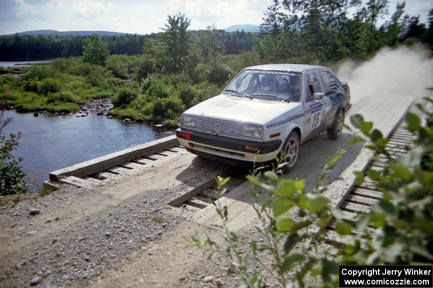 Brad Hawkins / Adrian Wintle VW Jetta at speed over a bridge on SS8, Parmachenee Long.