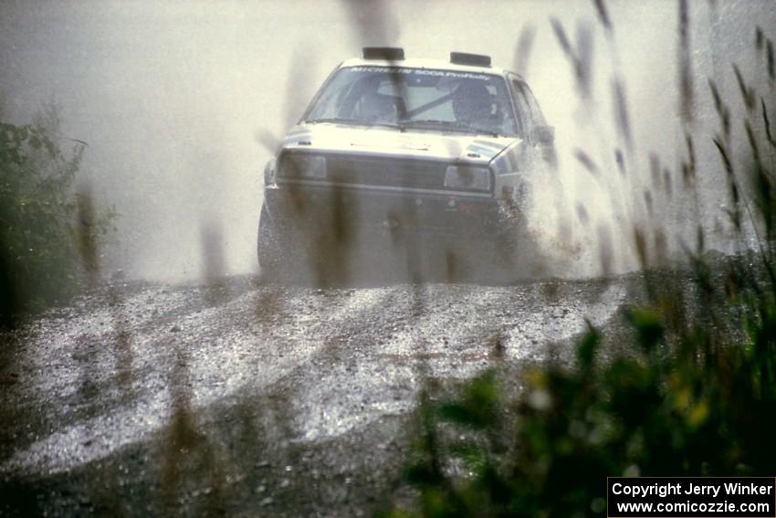 Eric Burmeister / Mark Buskirk VW GTI splashes through a puddle on SS8, Parmachenee Long.