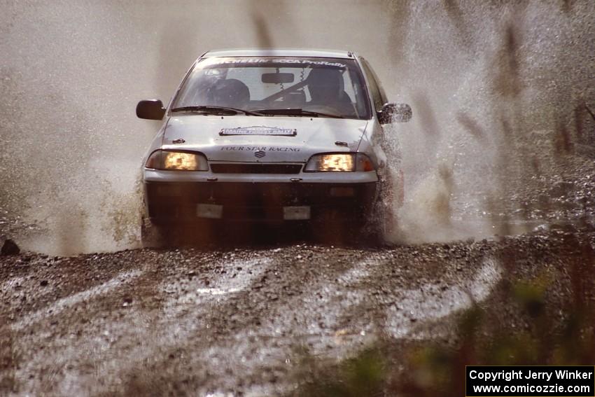 Ilana Rosenshein / Jennifer Cote Suzuki Swift GTi splashes through a puddle on SS8, Parmachenee Long.