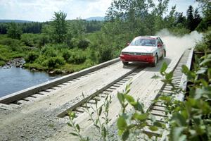 Arthur Wojcik / Chuck Cox Mitsubishi Galant VR-4 at speed over a bridge on SS8, Parmachenee Long.