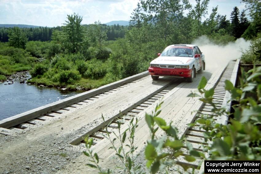 Arthur Wojcik / Chuck Cox Mitsubishi Galant VR-4 at speed over a bridge on SS8, Parmachenee Long.