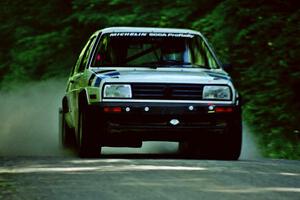 Eric Burmeister / Mark Buskirk VW GTI at speed on the practice stage.