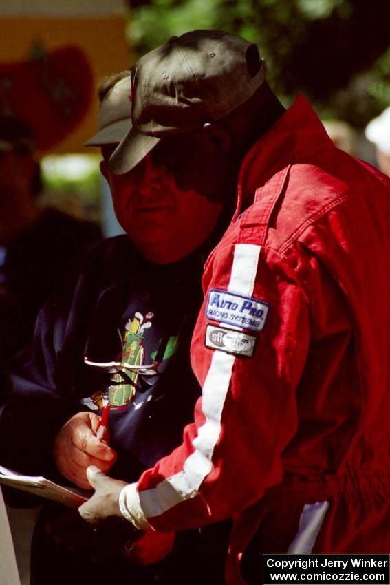 Arthur Odero-Jowi signs an autograph at the green in Wellsboro before the rally.