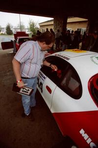 Dave Sutliff checks belts on the Miroslaw Babinski / Piotr Modzejewski Toyota Celica All-trac.