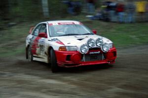 The Bill Morton / Mike Busalacchi Misubishi Lancer Evo IV at speed at the sweeper at the crossroads.