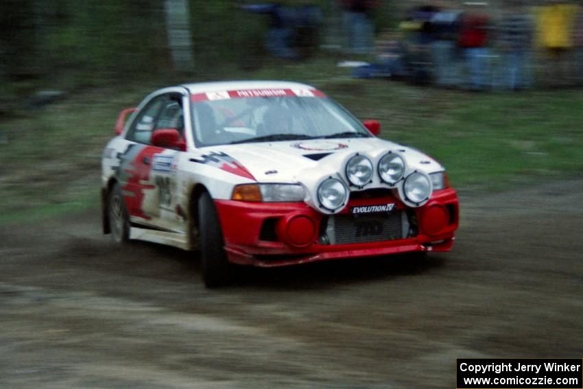 The Bill Morton / Mike Busalacchi Misubishi Lancer Evo IV at speed at the sweeper at the crossroads.