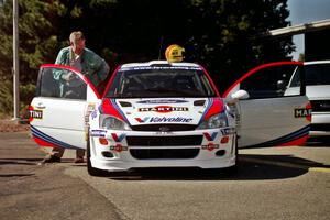 A member of the press views the interior of the Ford Focus WRC.