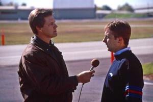 The mechanic on duty is interviewed by a member of the press.