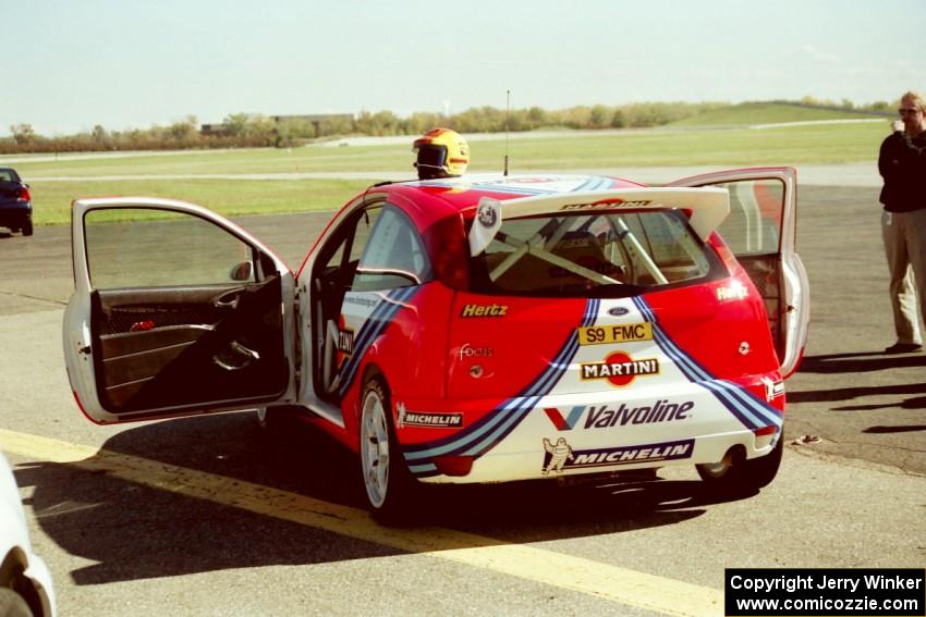 Ford Focus WRC on the tarmac open for viewing.