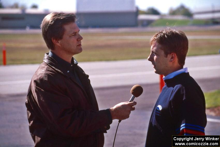 The mechanic on duty is interviewed by a member of the press.