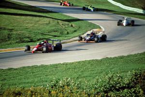 Five cars run nose-to-tail through turn 7