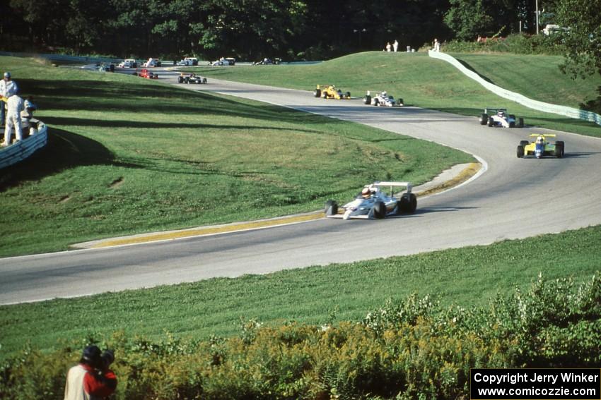 The field streams through turns 6 and 7 on the first lap.