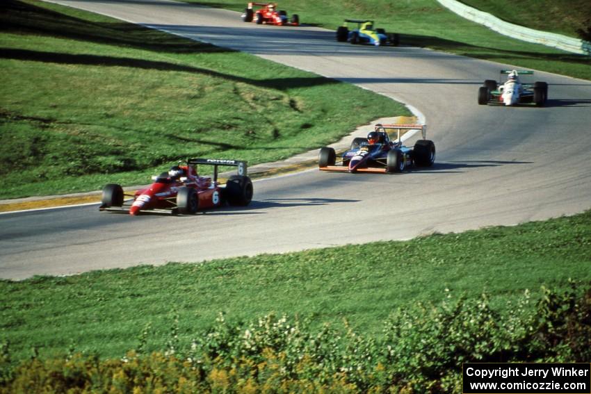 Five cars run nose-to-tail through turn 7