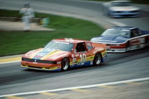 Don Sak's Olds Toronado ahead of Walter Payton's Olds Cutlass Supreme and Glenn Fox's Ford Mustang