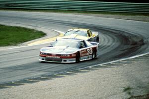 Scott Sharp's Olds Cutlass Supreme leads Tommy Kendall's Chevy Beretta