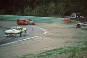 Tommy Kendall's Chevy Beretta leads as the Olds Cutlass Supremes of Darin Brassfield and Scott Sharp spin off