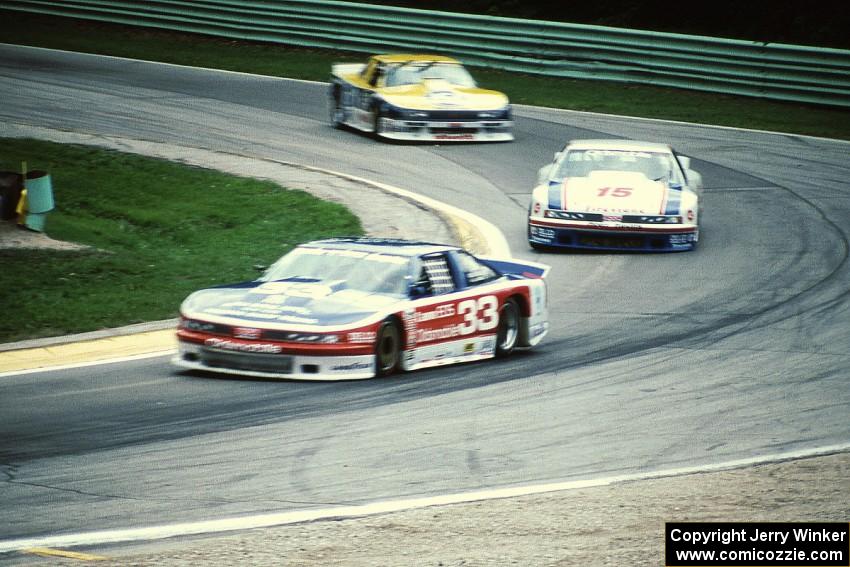 Scott Sharp's Olds Cutlass Supreme, Irv Hoerr's Olds Cutlass Supreme and Chris Kneifel's Chevy Beretta on lap two