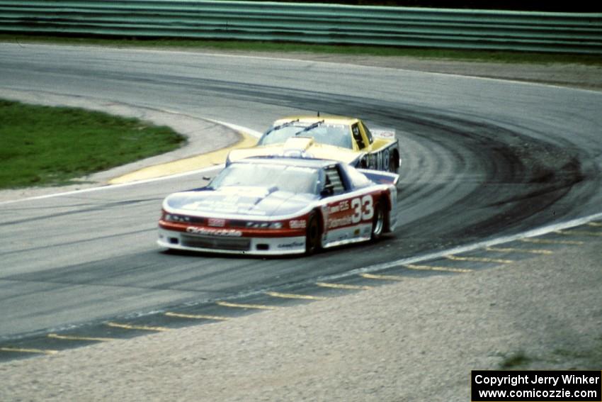 Scott Sharp's Olds Cutlass Supreme leads Tommy Kendall's Chevy Beretta