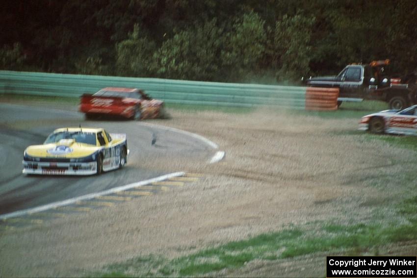 Tommy Kendall's Chevy Beretta leads as the Olds Cutlass Supremes of Darin Brassfield and Scott Sharp spin off