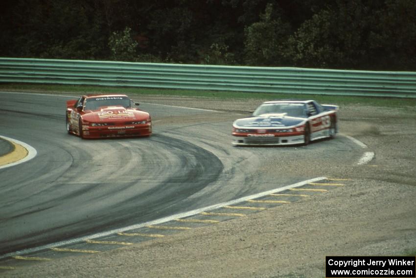 The Olds Cutlass Supremes of Darin Brassfield and Scott Sharp get back under way after spinning