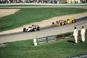 Al Unser, Jr.'s Lola T-90/00/Chevy followed by Bobby Rahal's Lola T-90/00/Chevy and Rick Mears' Penske PC-19/Chevy